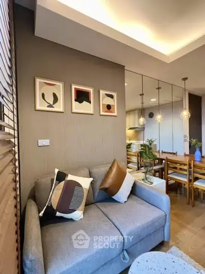 Stylish modern living room with cozy sofa and elegant dining area