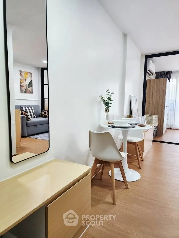Modern apartment interior with stylish dining area and cozy living room, featuring elegant decor and natural light.