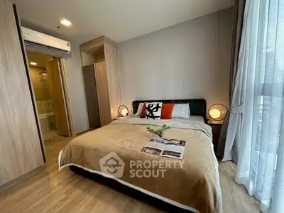 Modern bedroom with cozy decor and ensuite bathroom in a stylish apartment.