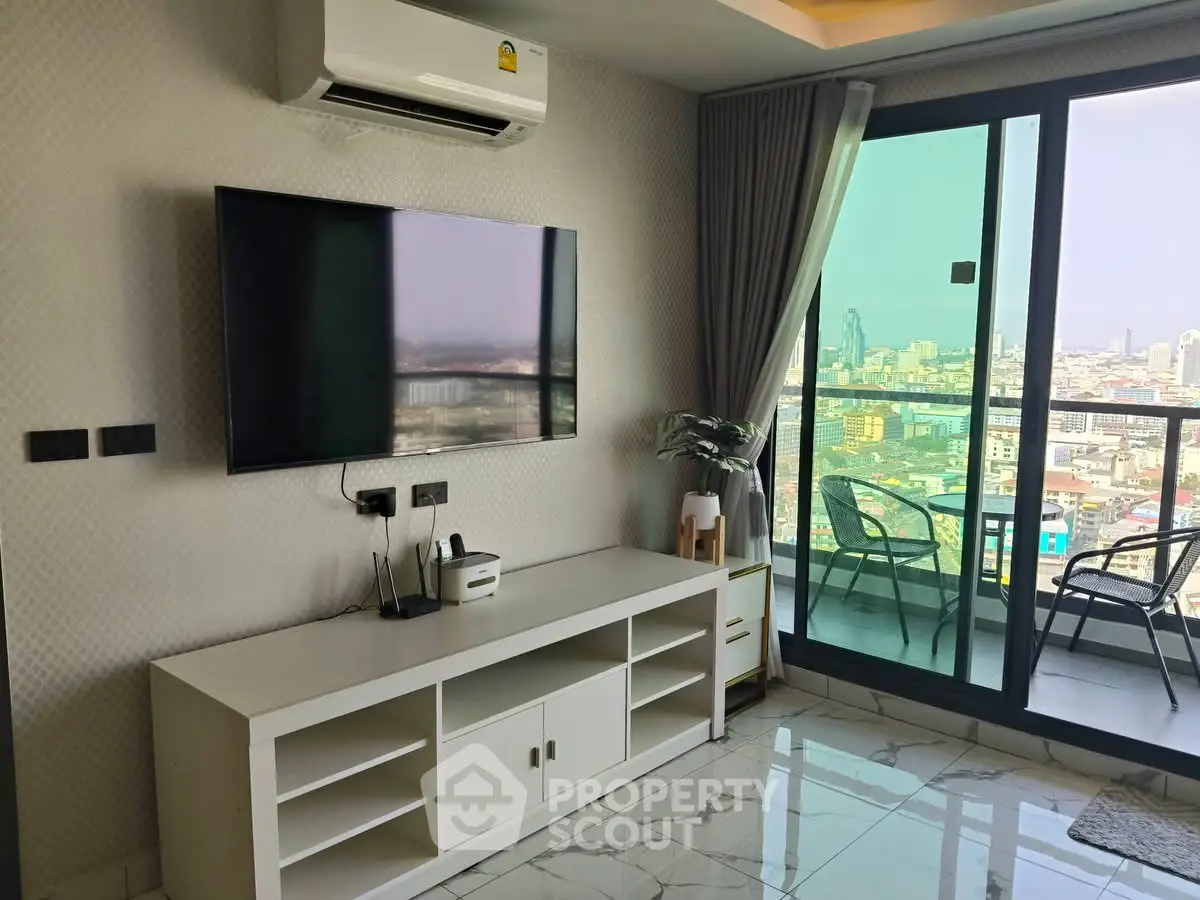Modern living room with city view balcony, sleek TV setup, and elegant decor.