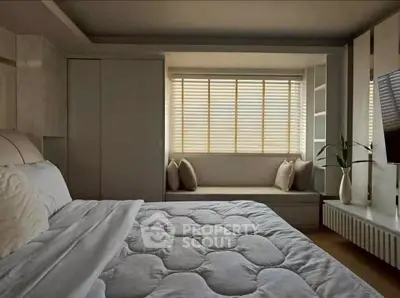 Cozy bedroom with modern decor and large window seat