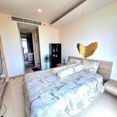 Modern bedroom with stylish decor and ensuite bathroom in a cozy apartment.