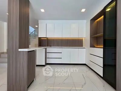 Modern kitchen with sleek cabinetry and marble flooring