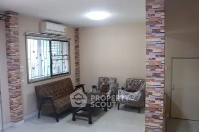 Cozy living room with modern furniture and air conditioning, perfect for relaxation.