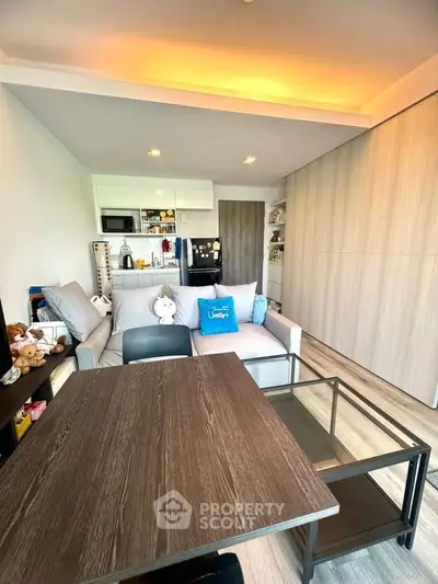 Cozy modern living room with stylish furniture and open kitchen layout, perfect for urban living.