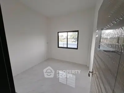 Spacious empty room with large window and glossy tiled floor, perfect for customization.