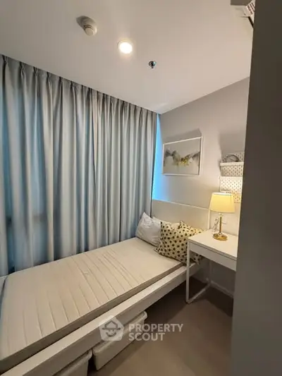 Cozy bedroom with single bed, stylish decor, and natural light for a serene living experience.