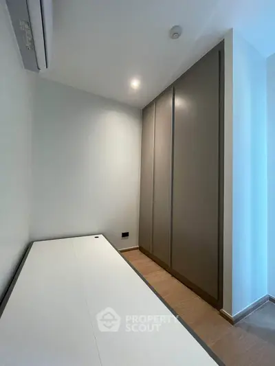 Modern study room with sleek built-in wardrobe and minimalist desk, perfect for productivity.