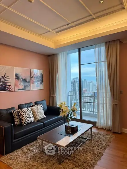 Elegant living room with city view, featuring modern decor and floor-to-ceiling windows.