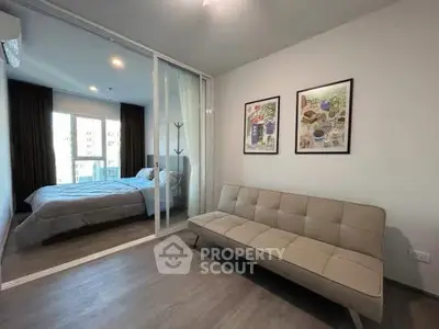 Modern apartment with cozy bedroom and stylish living area, featuring sleek decor and natural light.