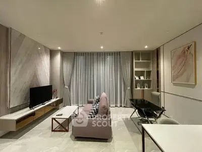 Modern living room with stylish decor and large windows, perfect for relaxation and entertainment.