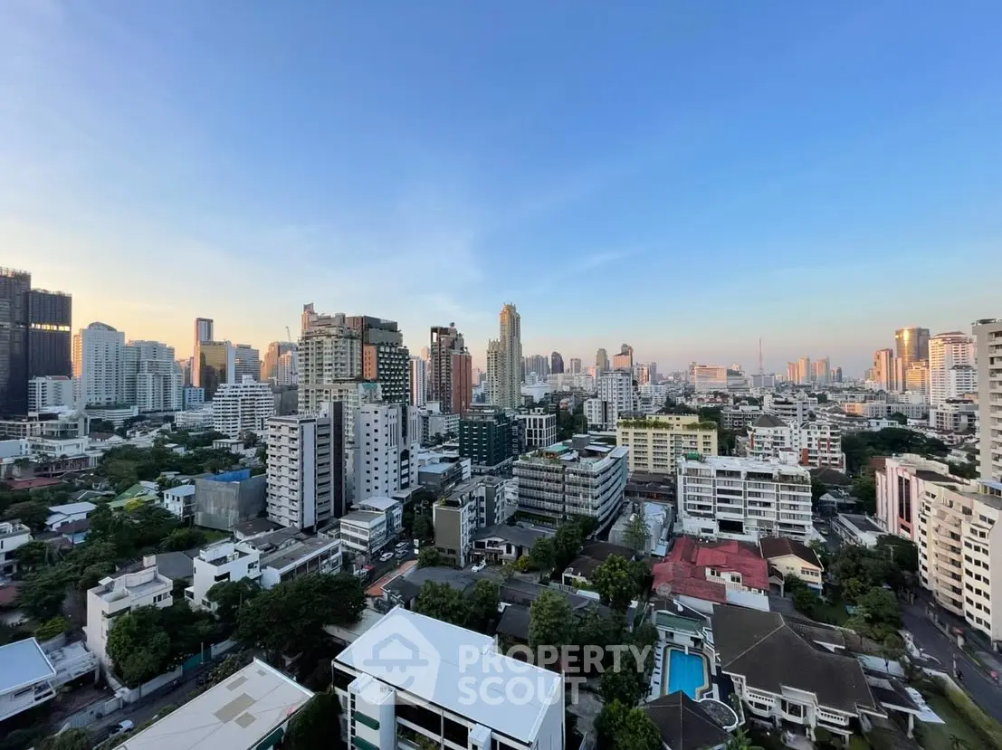 Stunning cityscape view from high-rise building at sunset, showcasing urban skyline and vibrant architecture.