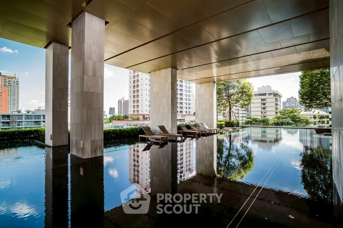 Luxurious high-rise building with serene rooftop pool and stunning city views.