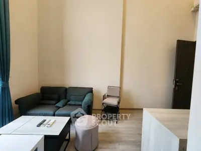 Modern living room with stylish furniture and natural light, perfect for relaxation and entertainment.