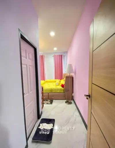 Charming bedroom with pastel walls and cozy decor, perfect for relaxation and comfort.