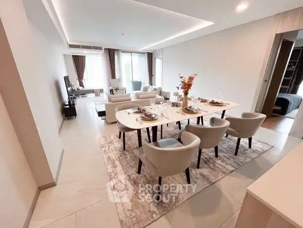 Spacious modern living room with elegant dining area and natural light.