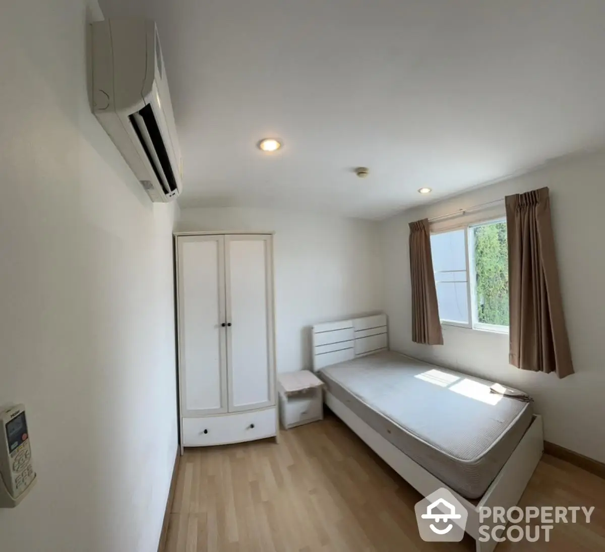 Spacious bedroom with natural light and modern air conditioning