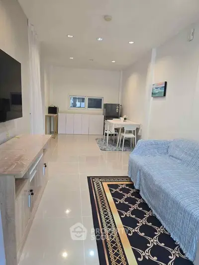 Spacious living room with modern decor and cozy seating area.