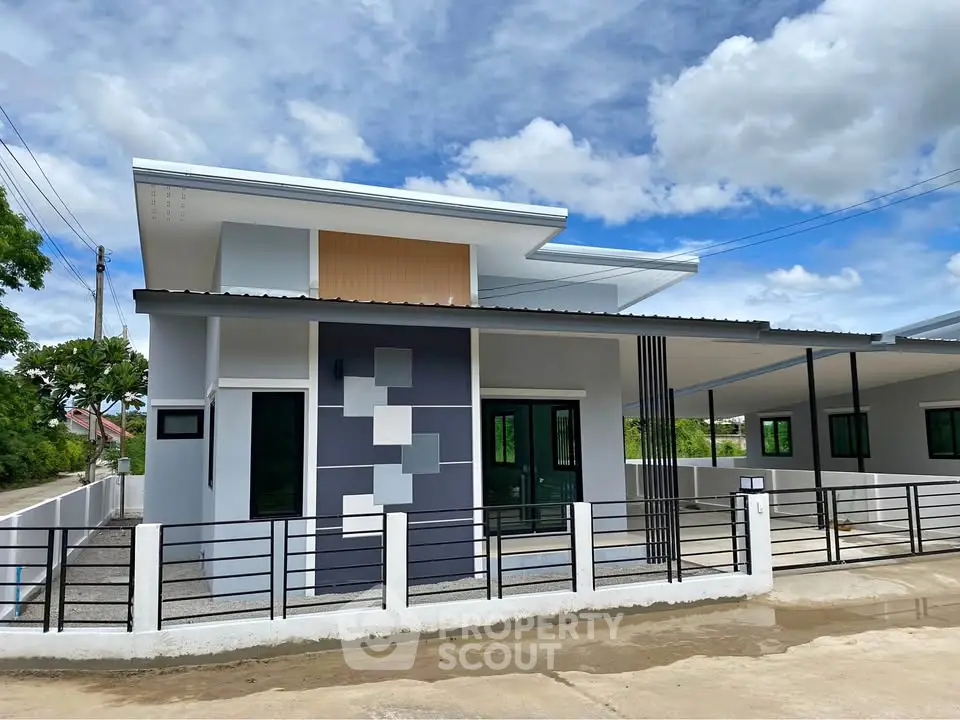 Modern single-story house with unique facade design and spacious driveway.