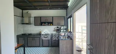 Charming kitchen with modern cabinetry and open layout, featuring sleek countertops and ample natural light.