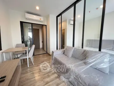 Modern living room with glass partition and stylish furniture in a contemporary apartment.
