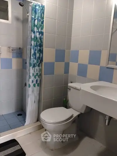 Charming bathroom with modern shower and stylish tile design, perfect for a cozy home.