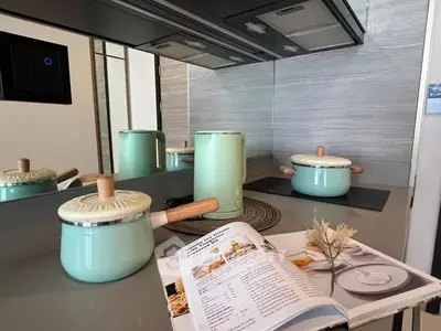 Modern kitchen with stylish mint green cookware and sleek appliances