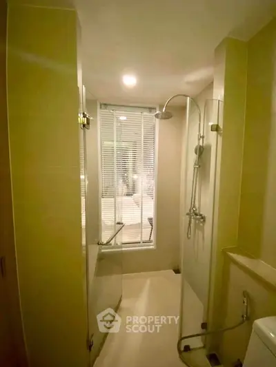 Modern bathroom with glass shower enclosure and sleek fixtures