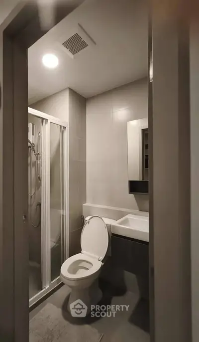 Modern bathroom with sleek shower and contemporary fixtures in stylish apartment.
