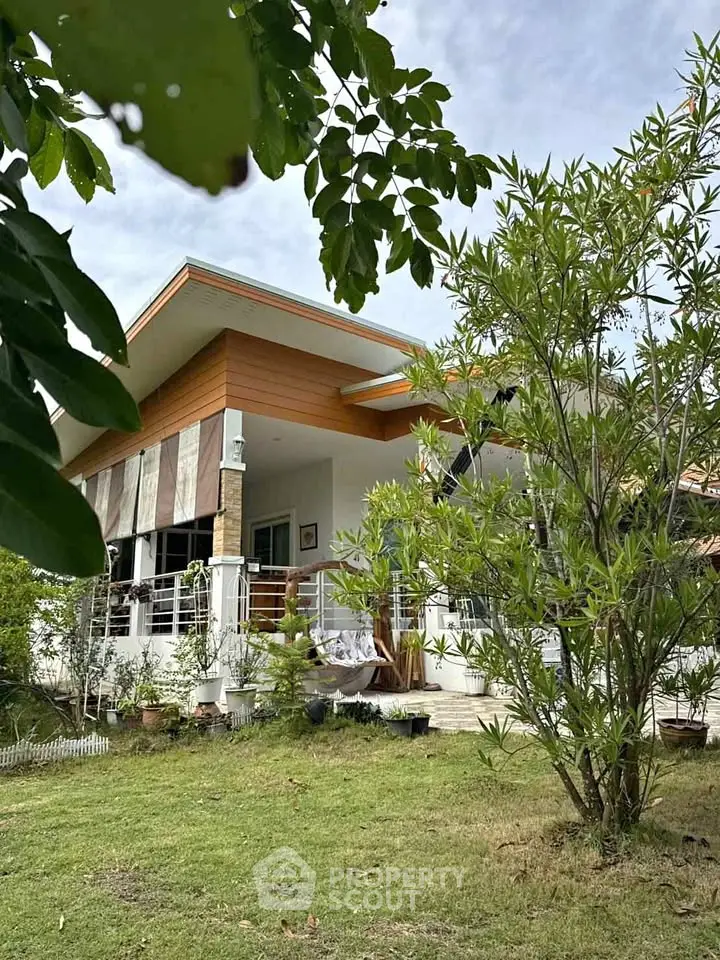 Charming modern house with lush garden and spacious balcony, perfect for serene living.