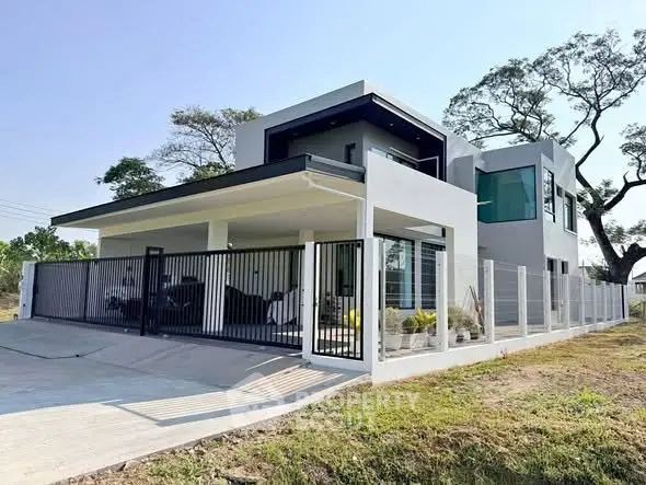 Modern two-story house with sleek design and spacious driveway in a serene neighborhood.