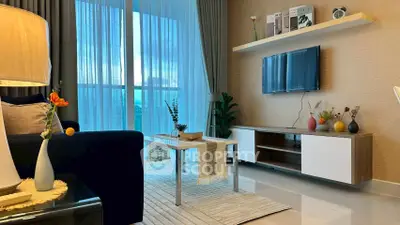 Modern living room with stylish decor, large window, and sleek furniture.