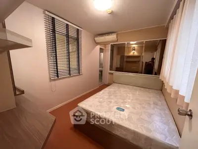 Cozy bedroom with modern furnishings and ample natural light, perfect for restful nights.