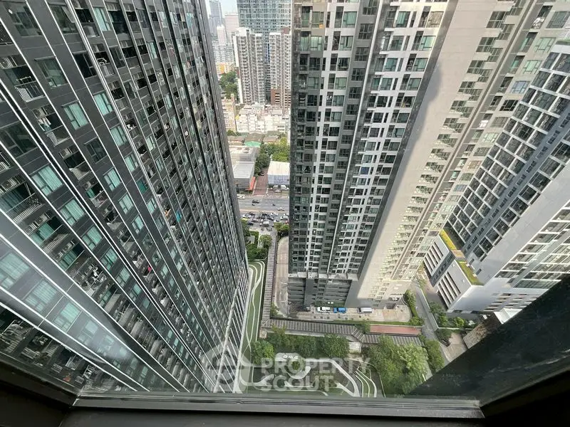 Stunning high-rise cityscape view from a modern urban apartment window.
