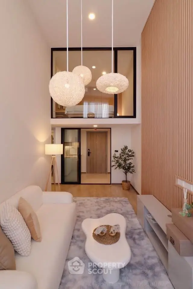 Modern living room with high ceiling and stylish lighting fixtures