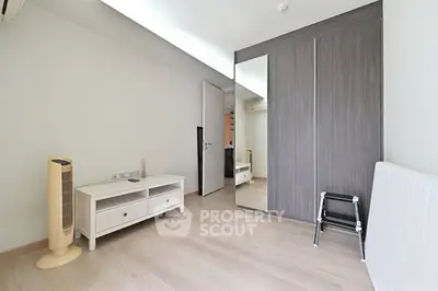 Spacious minimalist bedroom with modern wardrobe and sleek flooring