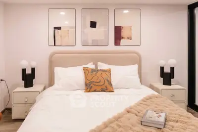 Cozy bedroom with modern decor and stylish lighting, perfect for relaxation.