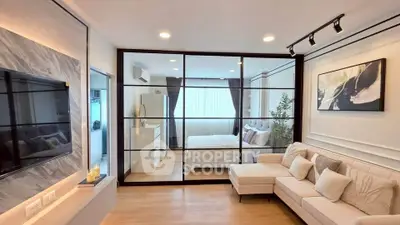 Modern living room with glass partition and cozy bedroom view