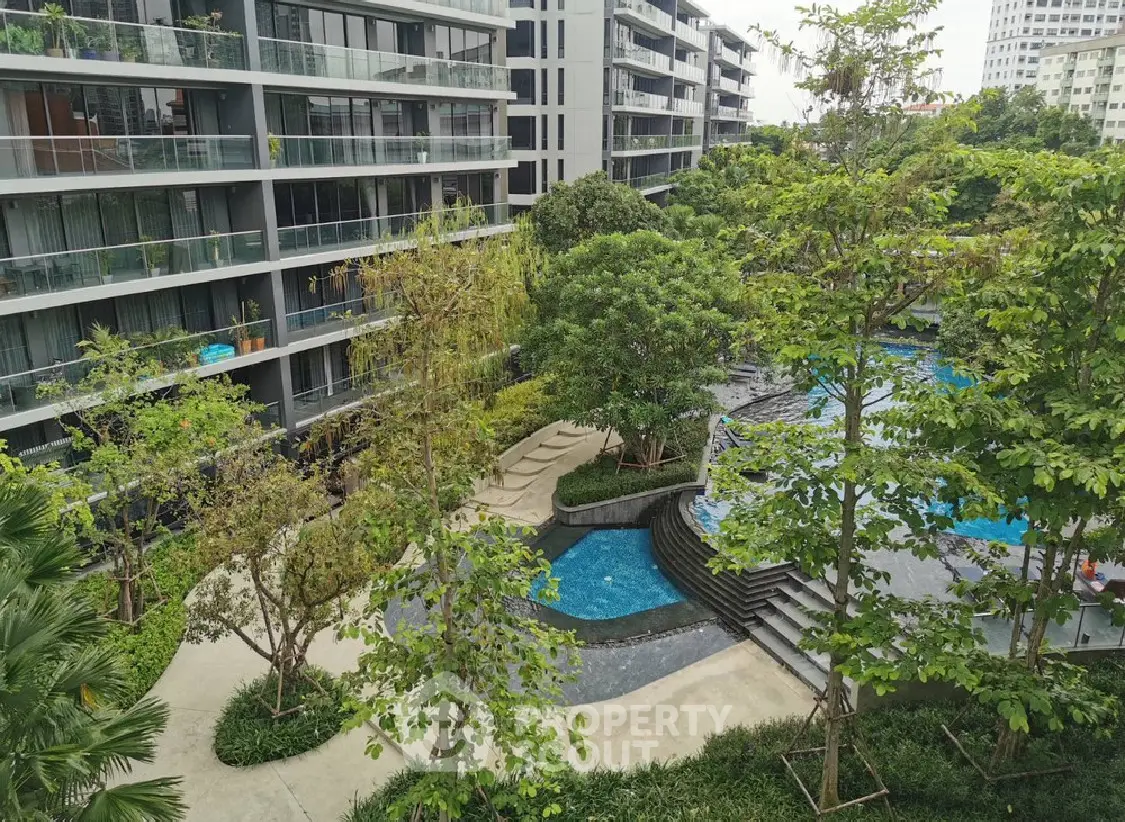 Luxurious residential complex with lush garden and inviting pool area
