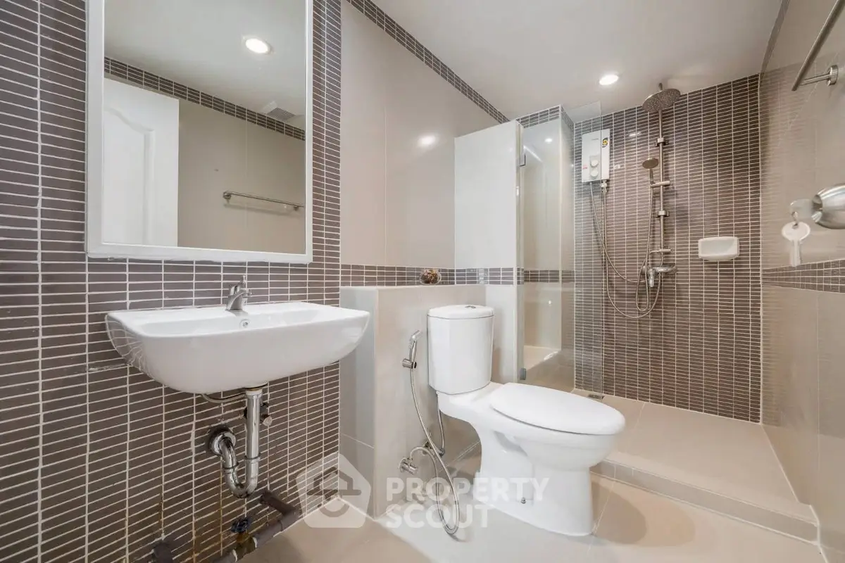 Modern bathroom with sleek design and spacious shower area.