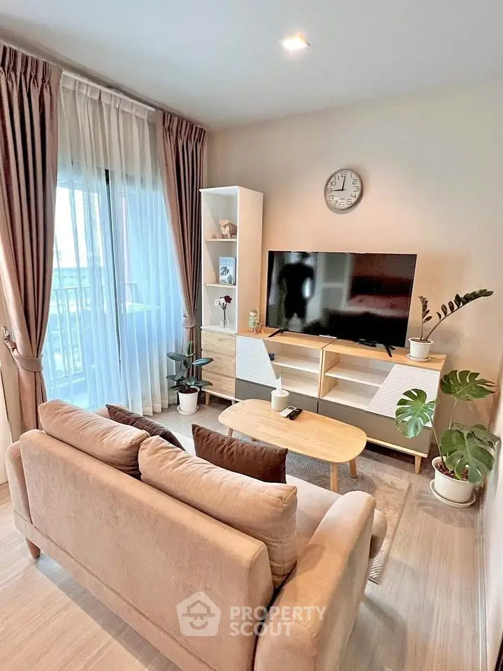 Stylish living room with modern decor, large TV, and cozy seating area, perfect for relaxation.