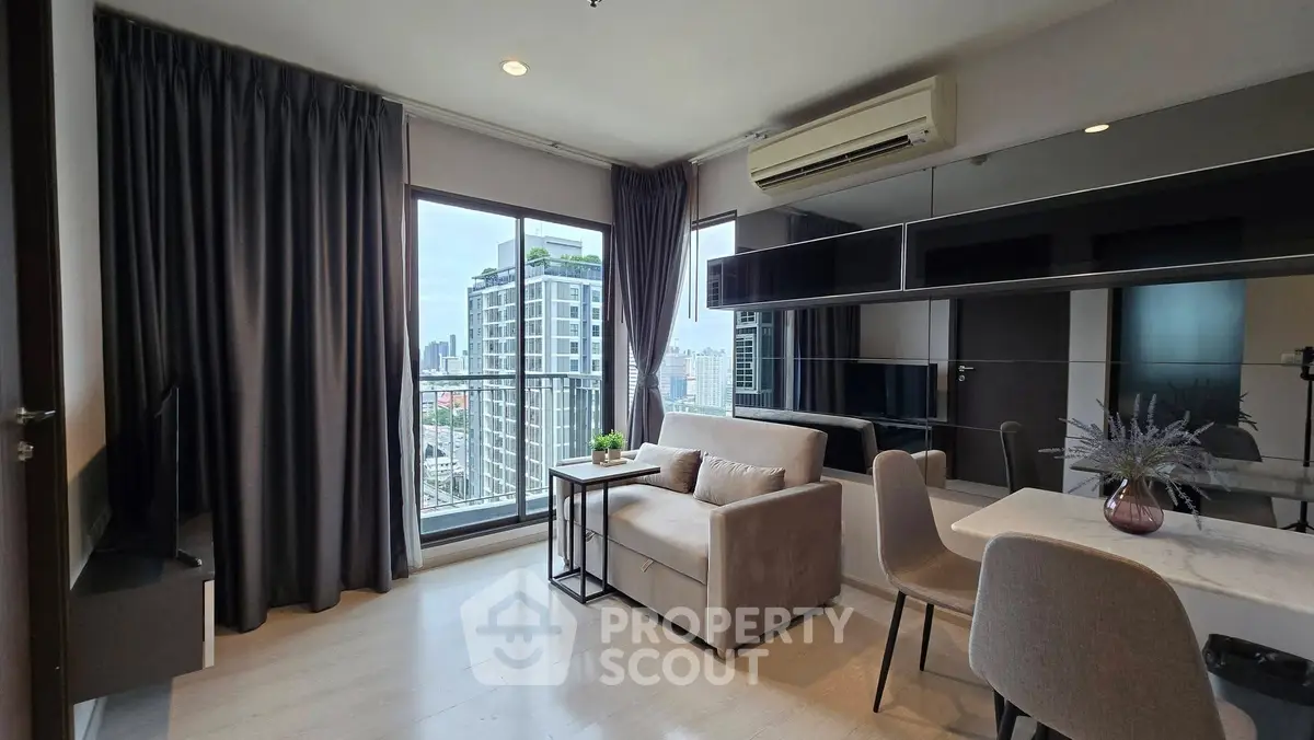 Modern living room with city view, featuring sleek furniture and large windows for natural light.