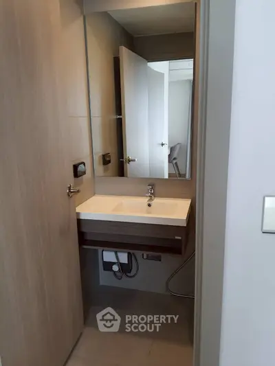 Modern compact bathroom with sleek sink and mirror design
