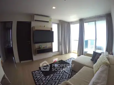 Modern living room with large windows and stylish decor in a high-rise apartment.