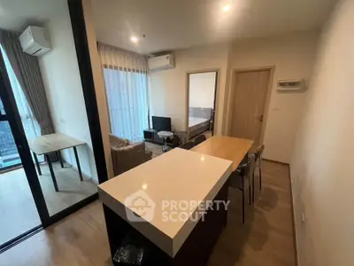 Modern apartment interior with open layout, featuring a cozy living area and dining space.