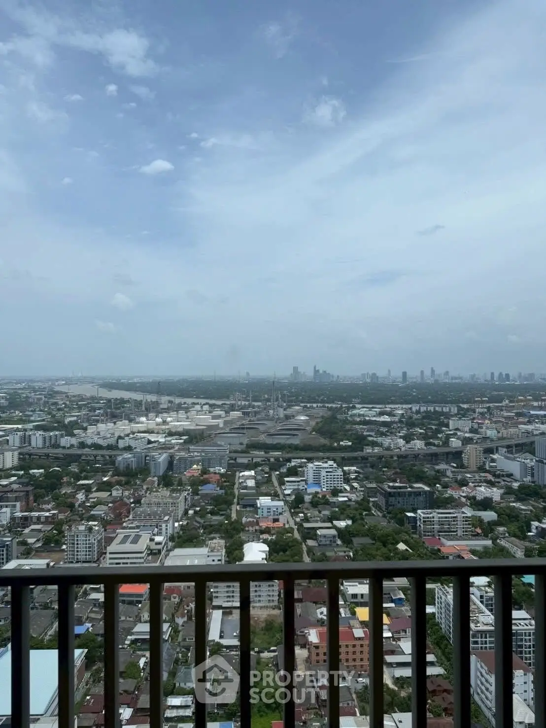 Stunning cityscape view from high-rise balcony with expansive skyline and urban landscape.