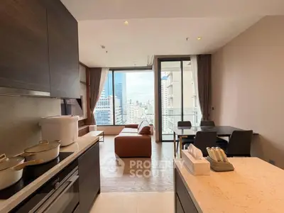 Modern open-layout kitchen and living room with city view balcony in luxury apartment.