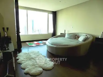 Luxurious bedroom with unique round bed and city view