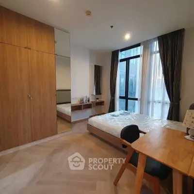 Modern bedroom with wooden furniture and large window in a stylish apartment