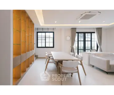 Modern living room with elegant dining area and large windows